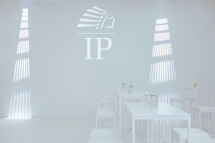Lounge-Bereich mit projiziertem IP-Logo vor Eventbeginn